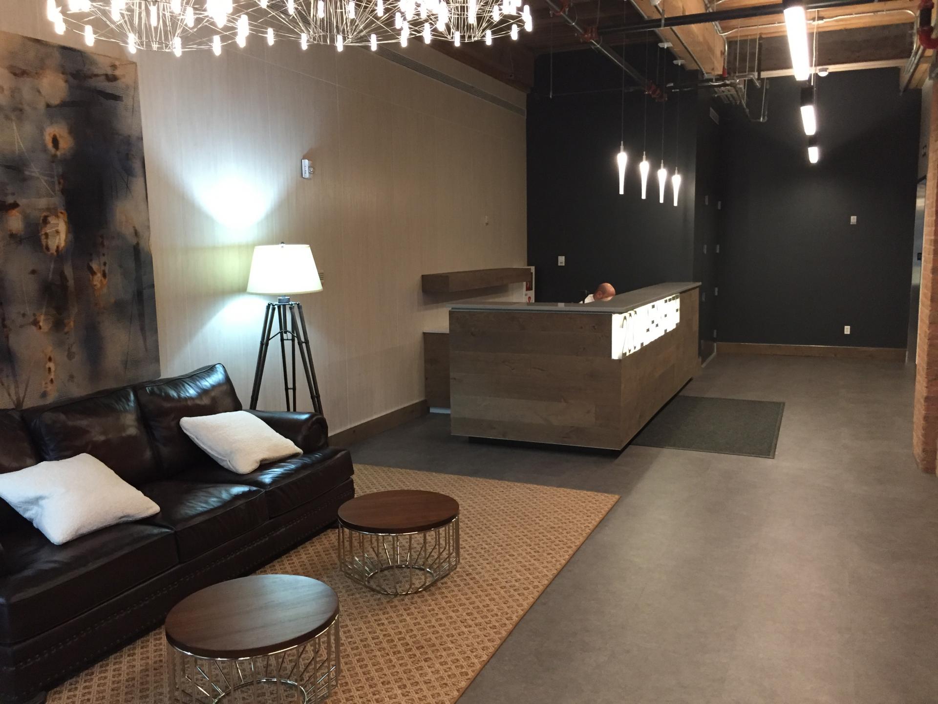 The building lobby redesigned with earthy tones, comfortable seating and subtle lighting